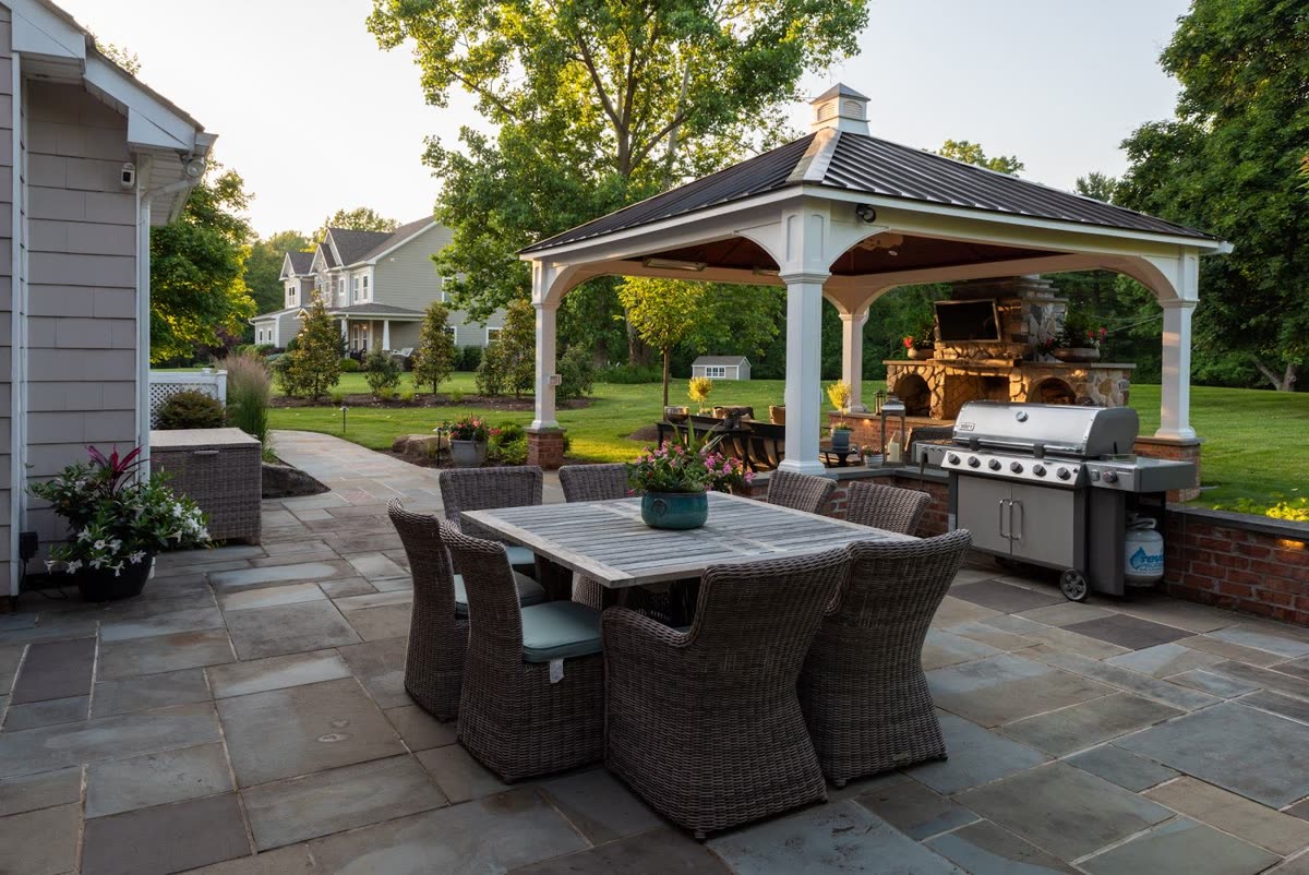 Outdoor kitchen pavilion with stone hardscape by Green Diamond