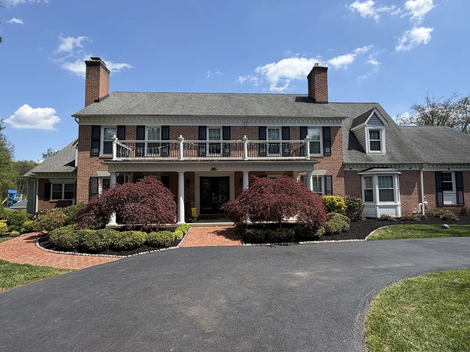 Colonial home with fresh mulch beds and curb-appeal landscaping