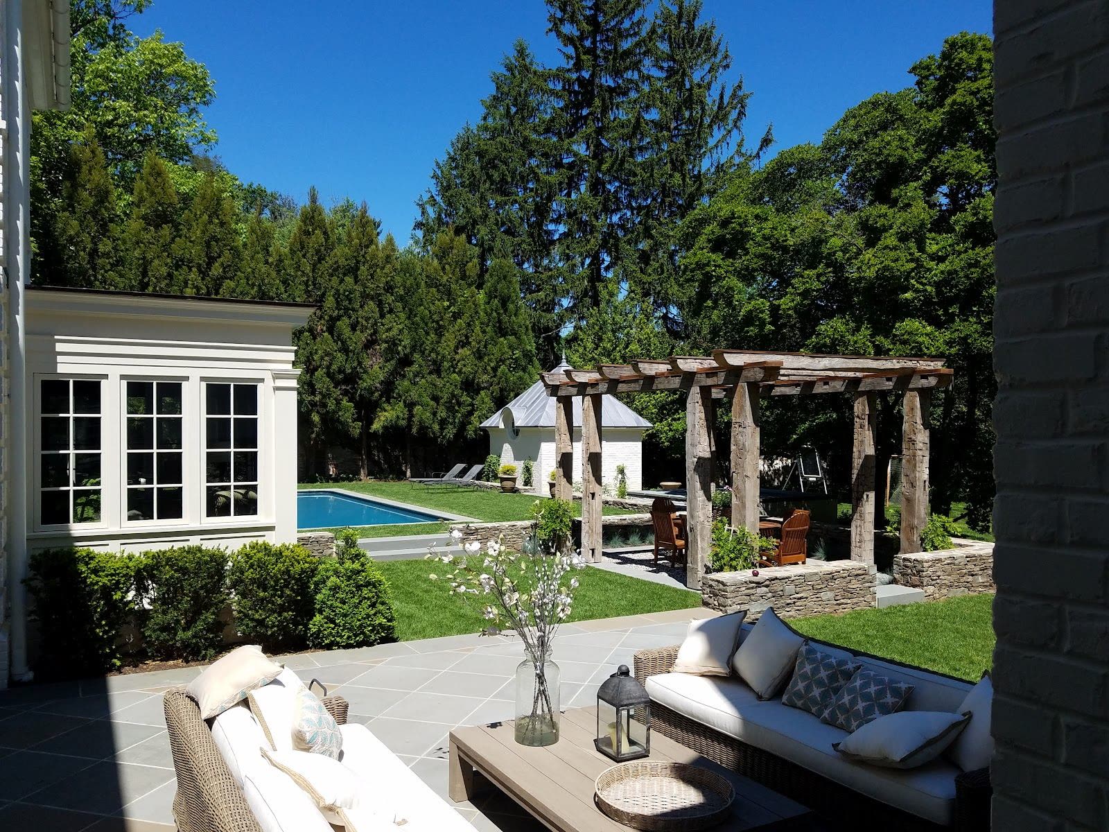 Pool patio with pergola and stone hardscape by Green Diamond